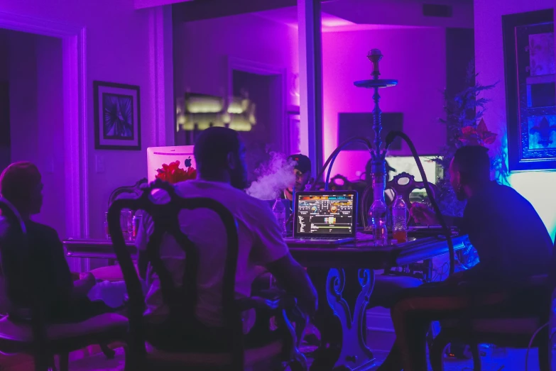 a group of people are around the table playing video games