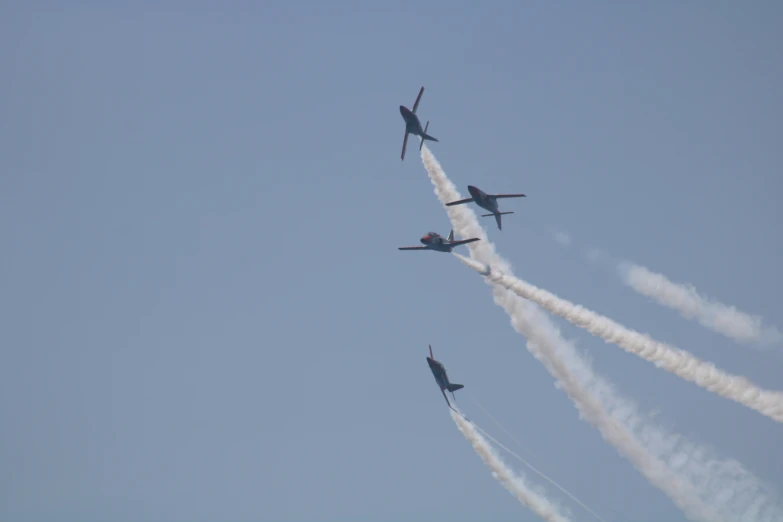 four jet planes are flying in the sky together