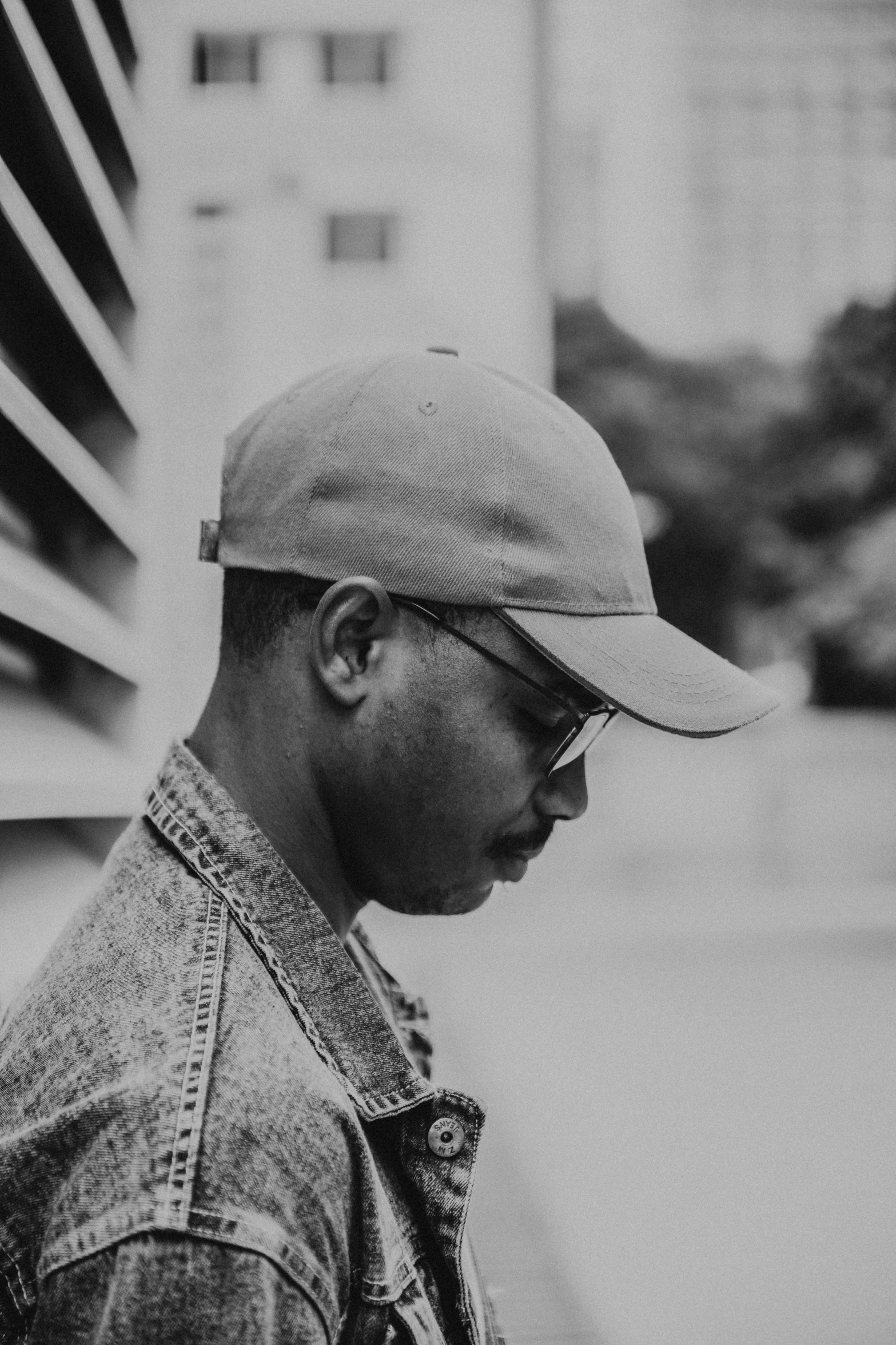 a black man with sunglasses and a hat on