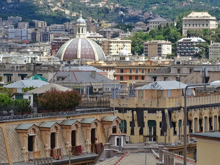 view of roofs, buildings and a dome shaped building in the distance