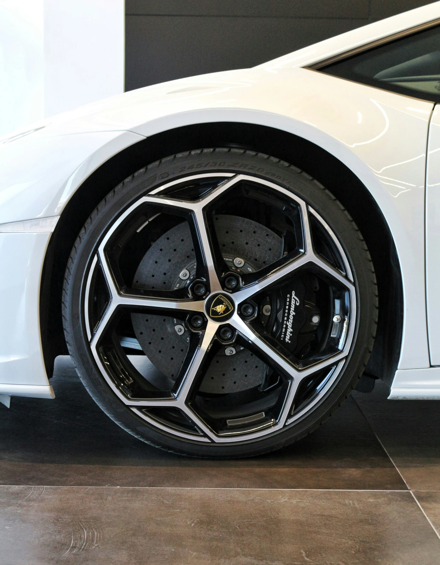 the wheels on a white sports car look sleek and shiny