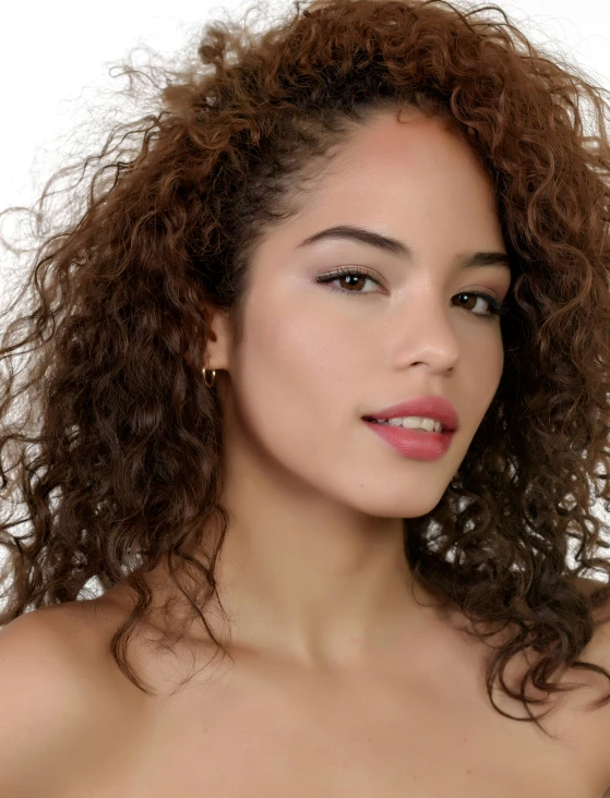 a woman posing with her long dark hair in front of white backdrop