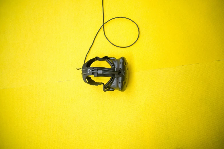 a bicycle with an attached handle sits against a yellow wall