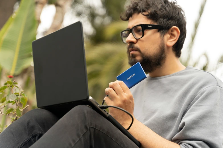 a man is on his lap while holding a credit card