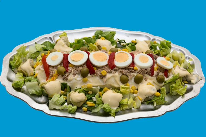 a serving dish with three eggs and sliced green olives on top