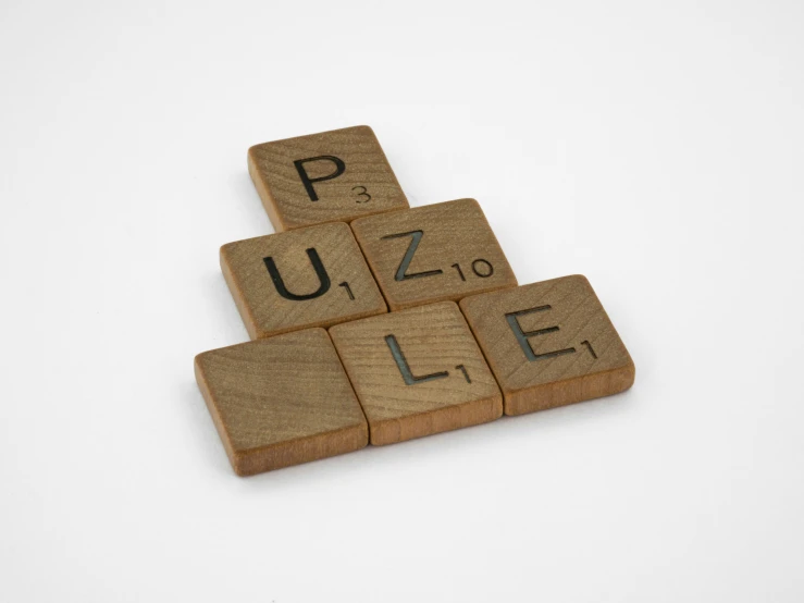 a wooden puzzle with letters written on it