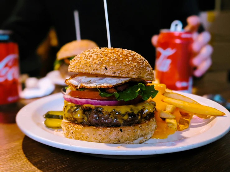 the hamburger is piled high with lettuce, tomato and cheese