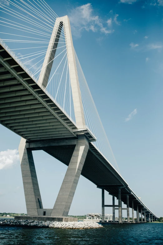 a bridge is shown with a boat passing by it