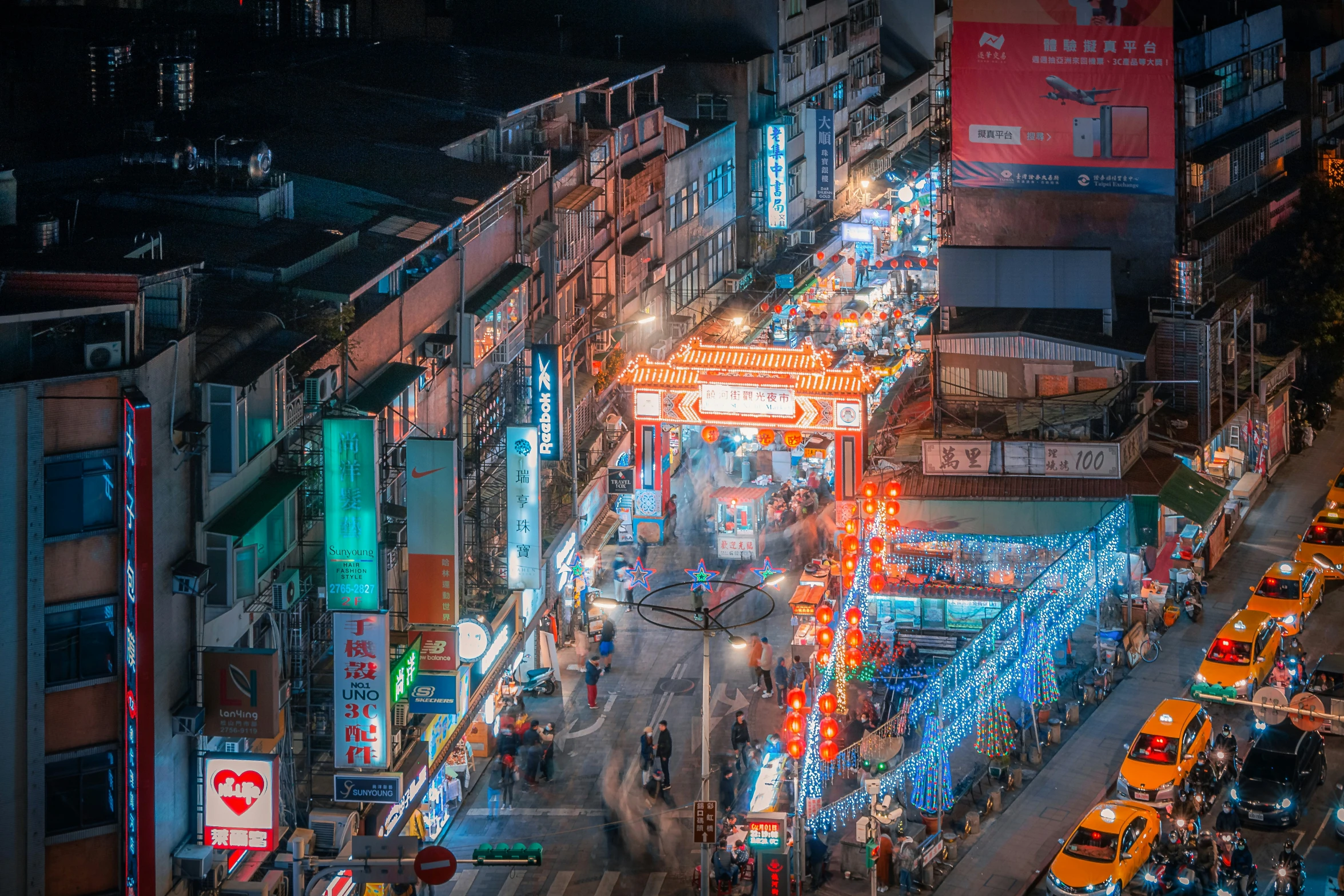 a large city with people walking along a busy street