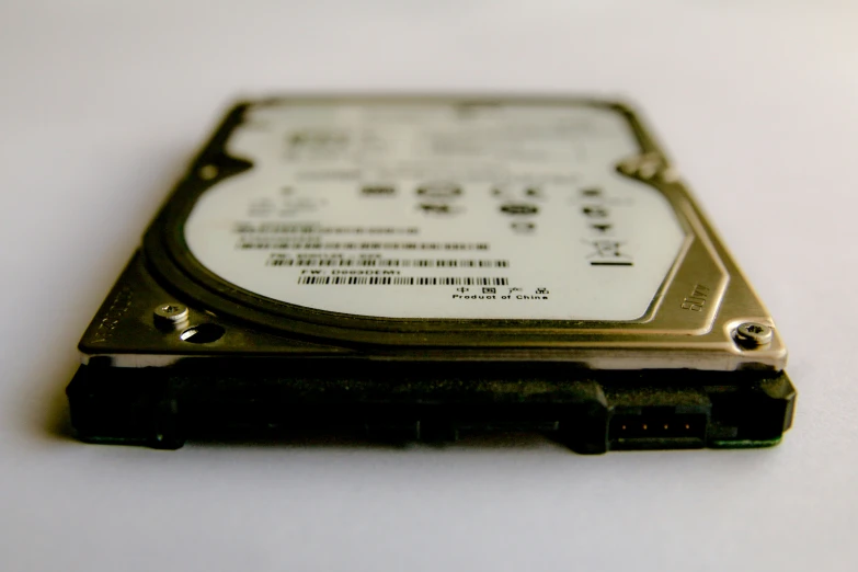 a computer hard drive is attached to the back end of a laptop