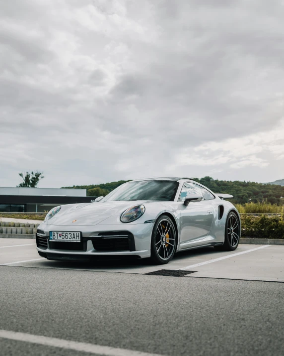 a silver sports car parked in a lot