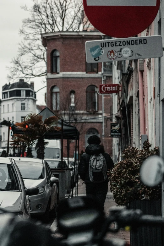 a stop sign with a man in the middle walking