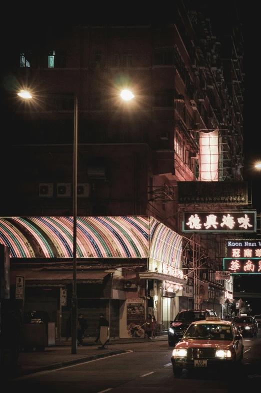 a car driving down the street at night