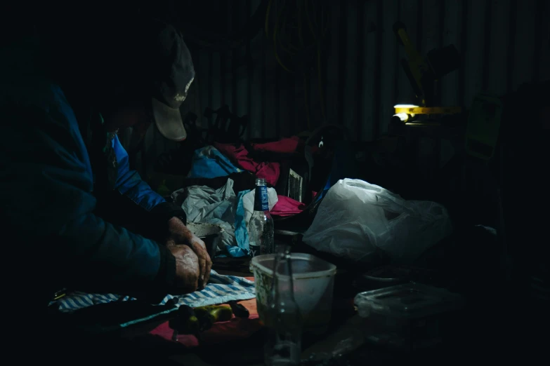 two people sitting at a table in the dark