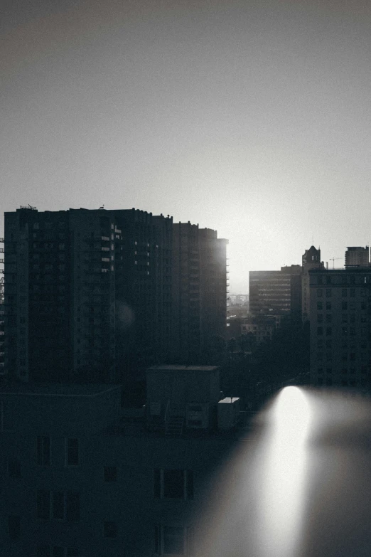 the city is silhouetted in the sunlight over water