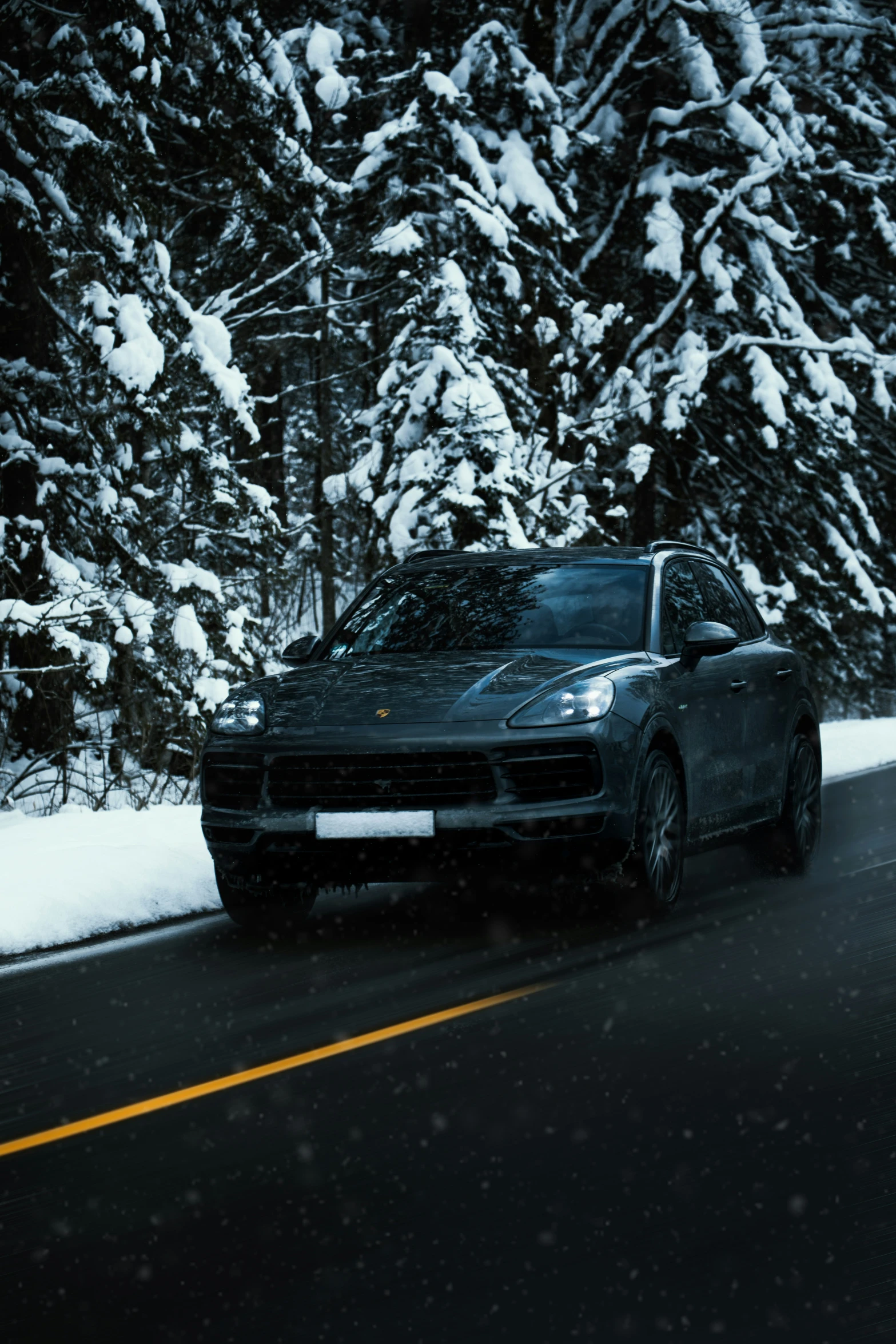 an suv parked on the side of the road in the winter