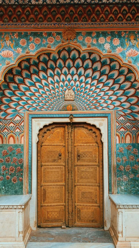 a tall golden doorway in an intricately painted building