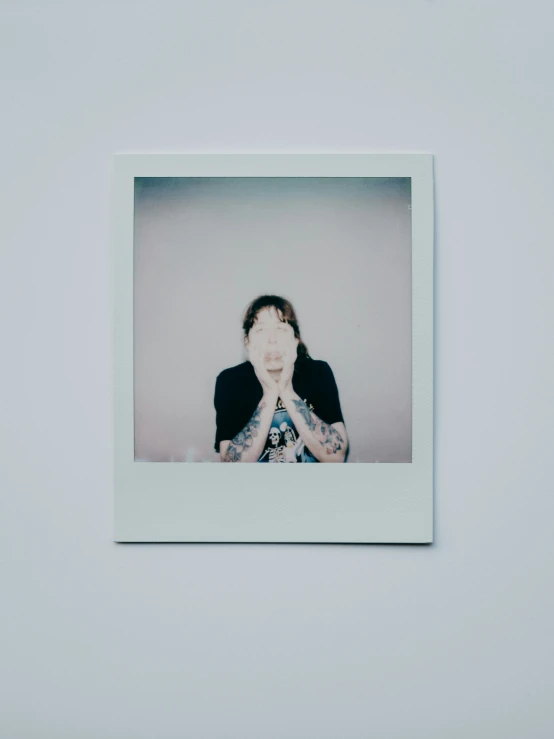 a man sitting down in front of a polaroid style pograph