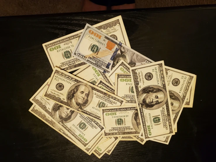 a pile of money that is laying on a table