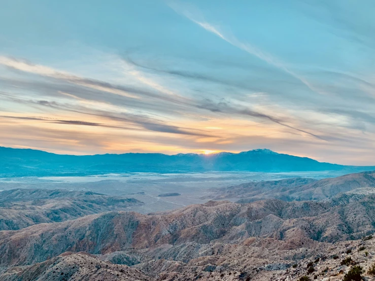 a po taken from the top of a mountain with the sun setting