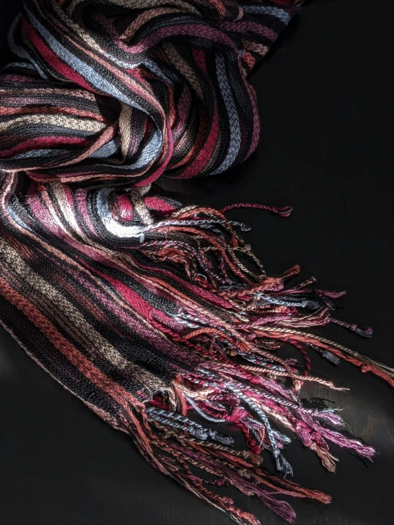 the scarves are colorfully striped with fringes