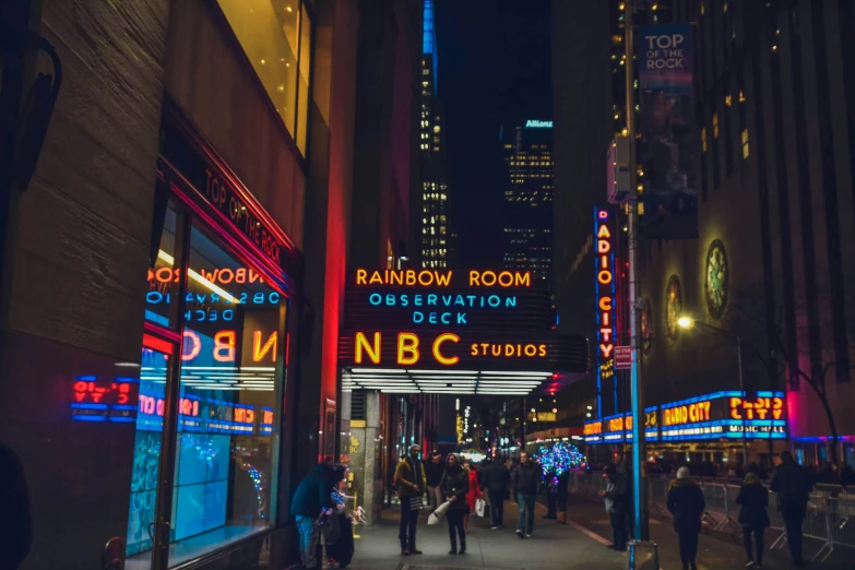 a busy downtown night scene with neon signs