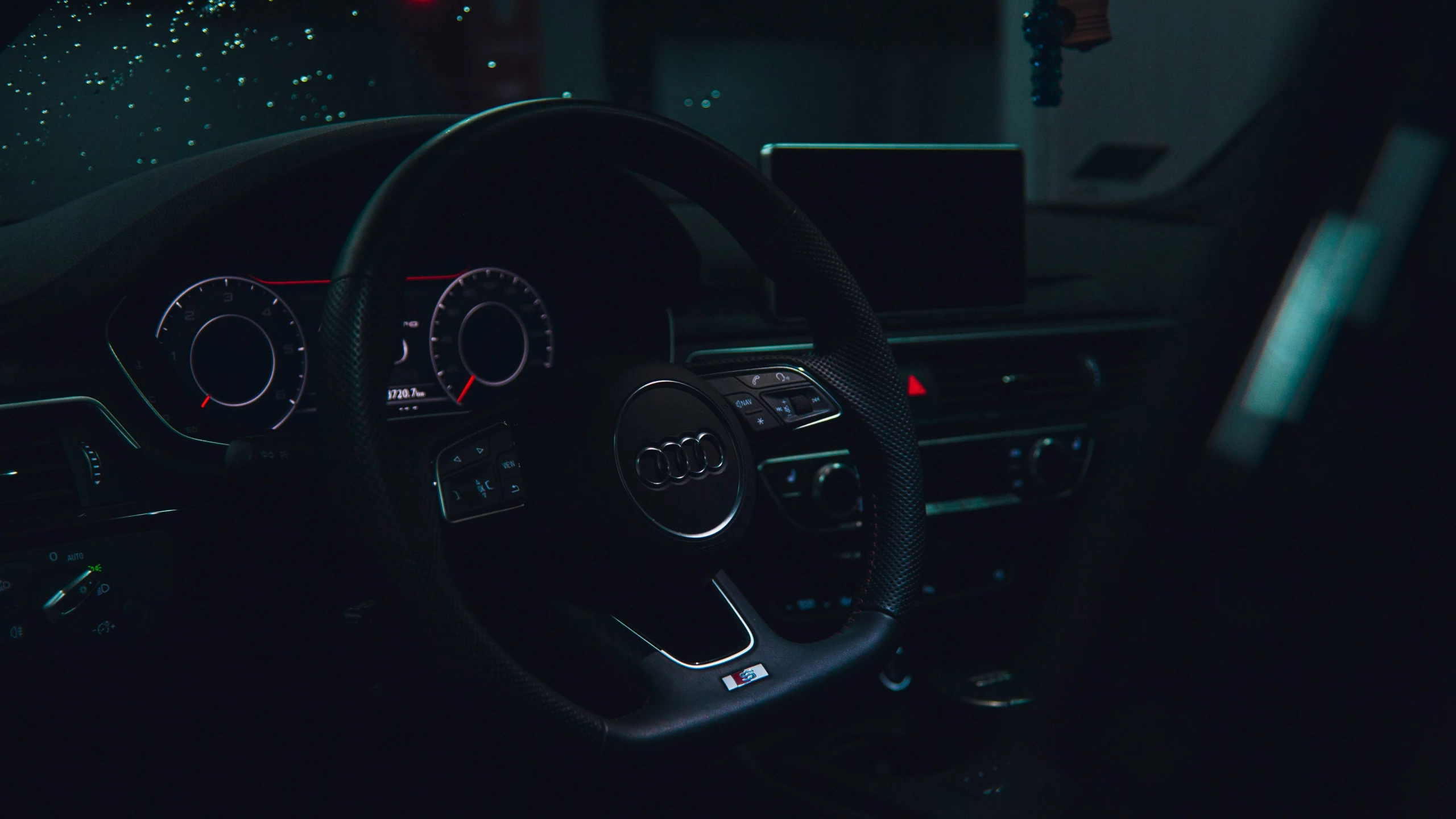 dashboard view with steering wheel and illuminated display