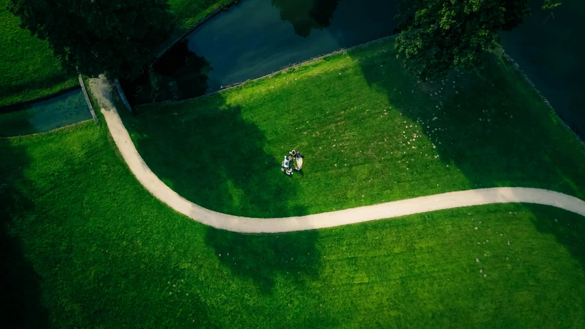 some small people standing in the middle of a grassy field