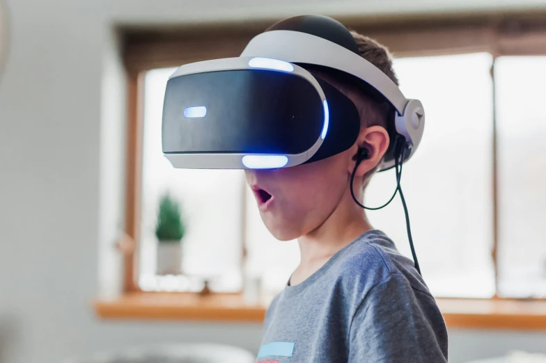 a boy standing in a living room wearing a virtual headset