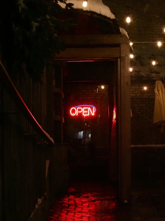 an open door with the word closed hanging from the ceiling