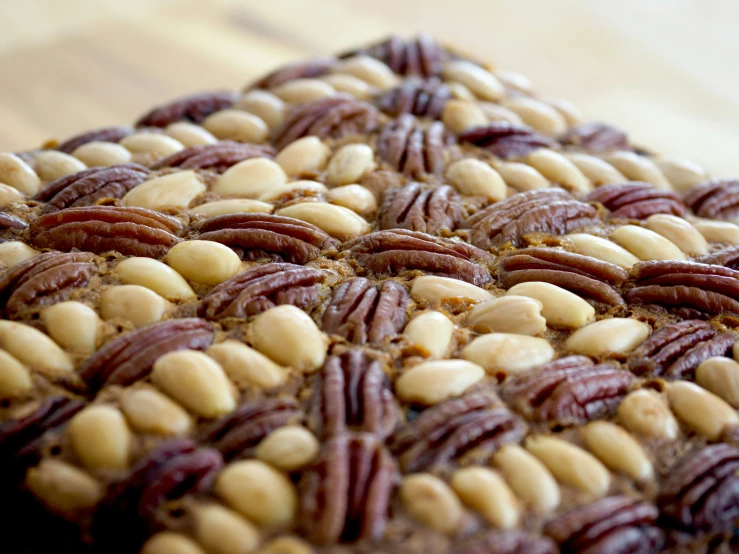 there is a cake topped with nuts and chocolate