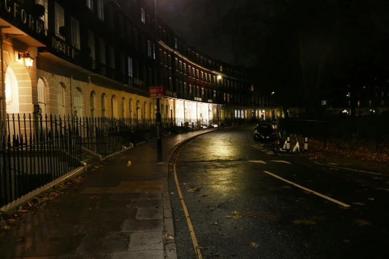 street corner with buildings on either side at night