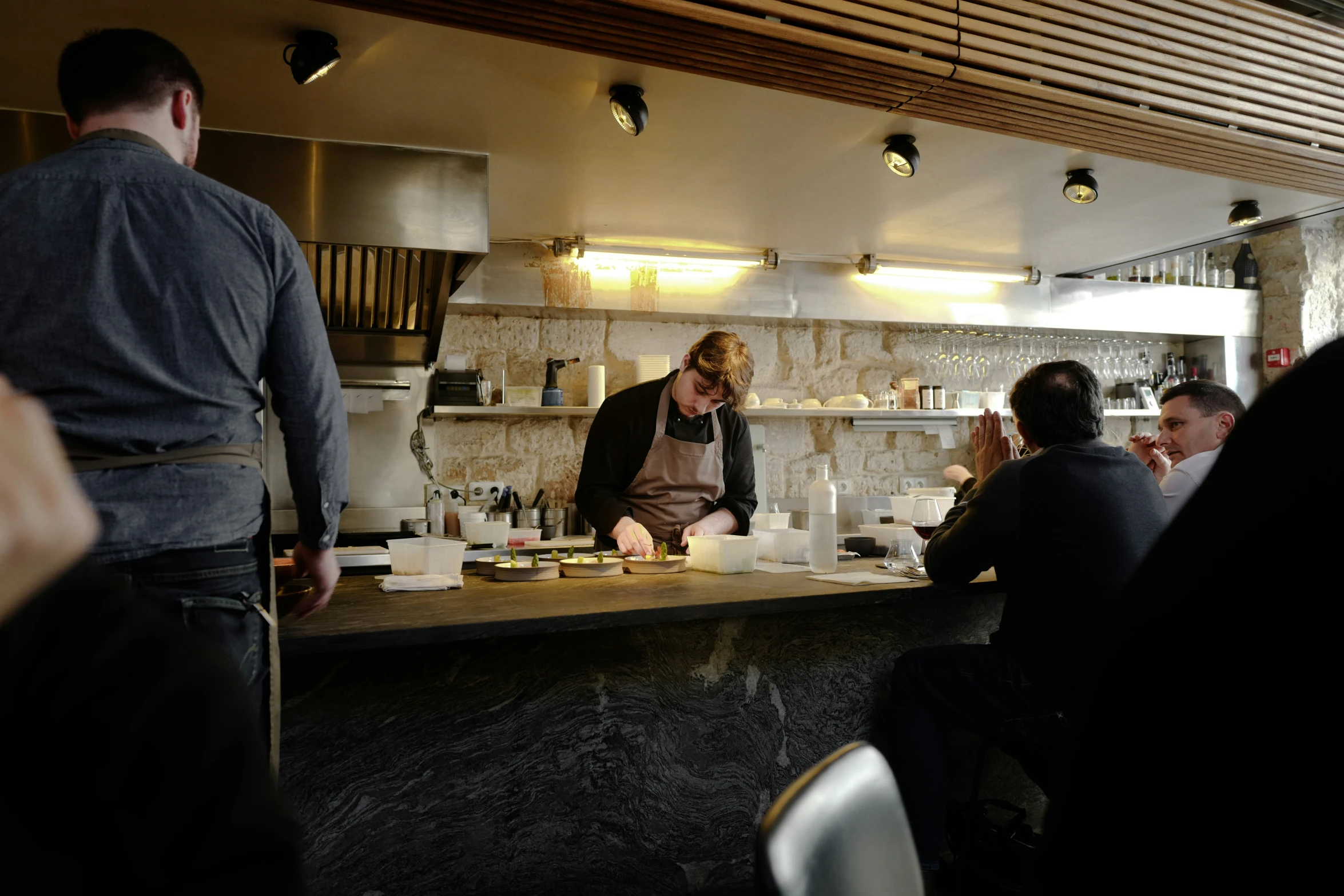 a group of people are seated at a bar