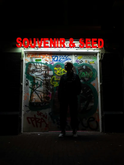 a person standing in front of a window covered in graffitti