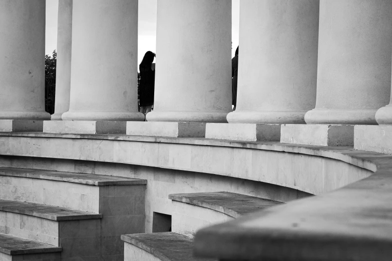 a person standing outside of an area with pillars