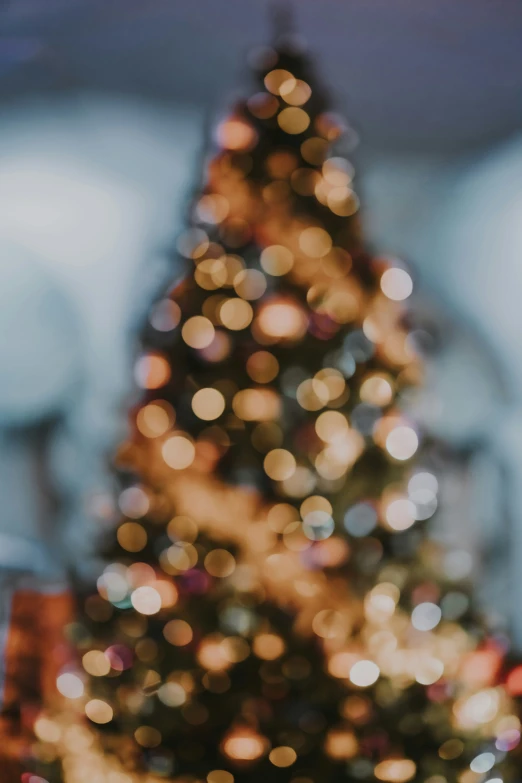 a lit up tree is on display with blurred lights