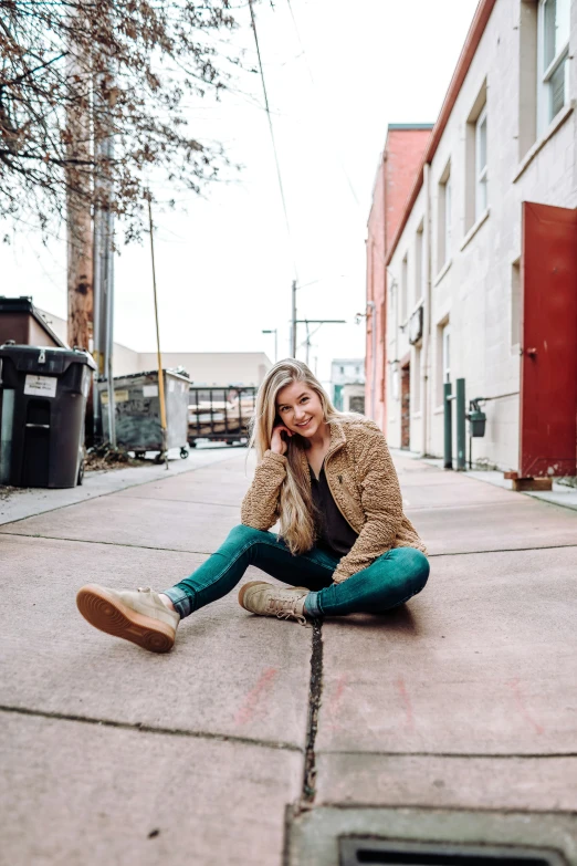 a woman is sitting on the ground near a fire hydrant