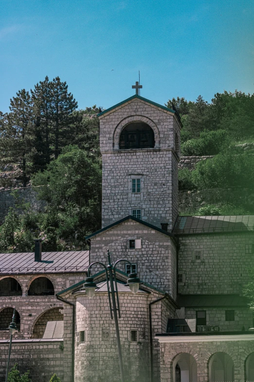 old brick church with clock tower in forest area