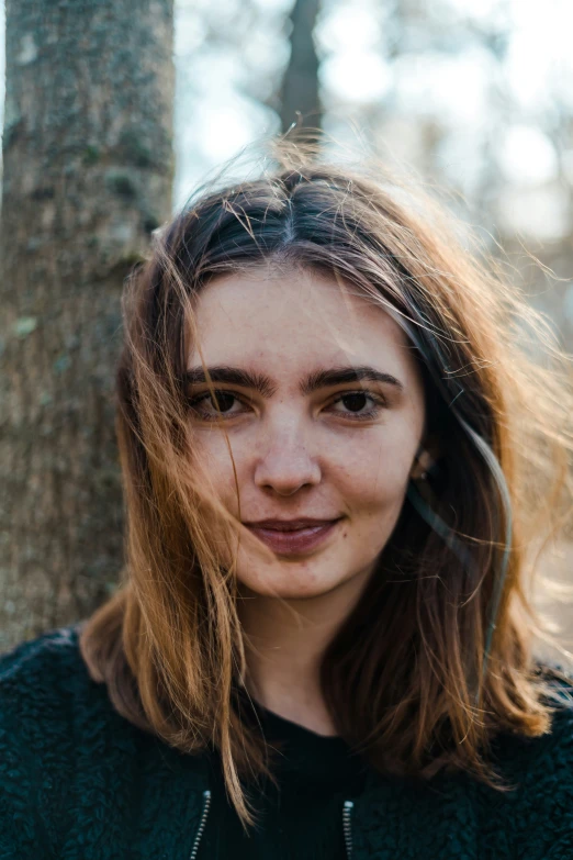 a woman smiling in a park setting