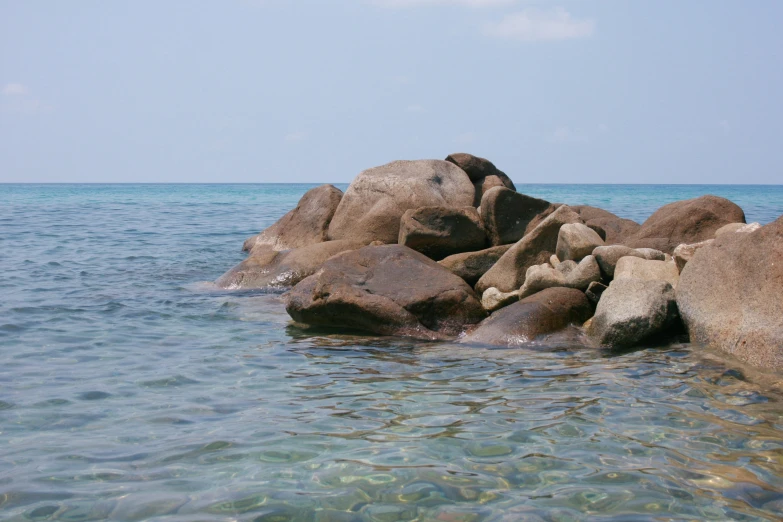 the rock outcrop is next to the ocean