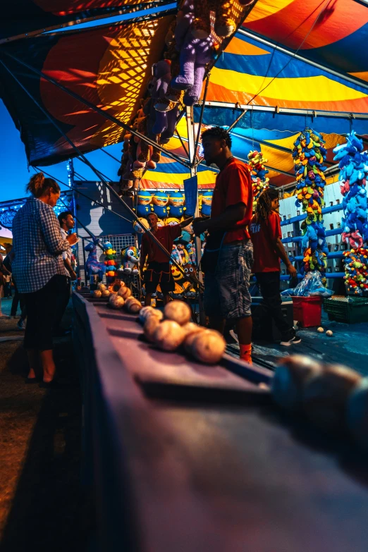 people are shopping for some fruit under umbrellas