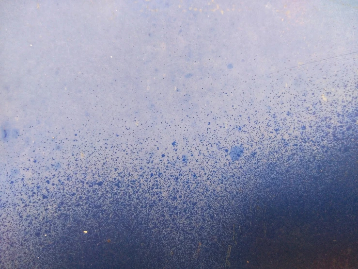 blue drops of rain falling down on the surface