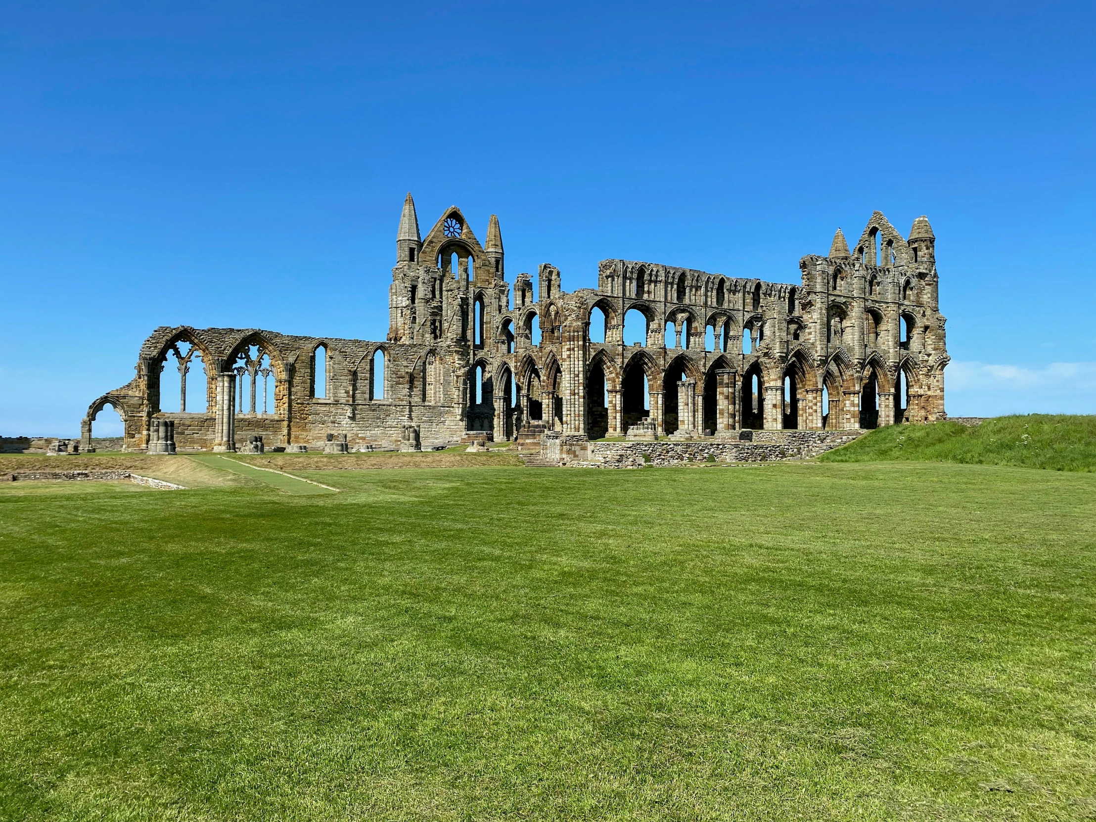 a very large building with windows on a big field