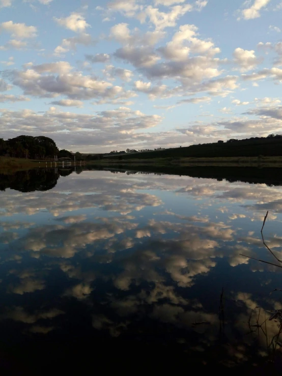 there are clouds that are reflecting in the water