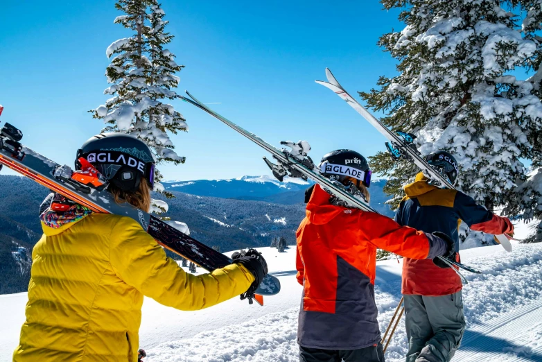 a group of people carrying their skis on a mountain