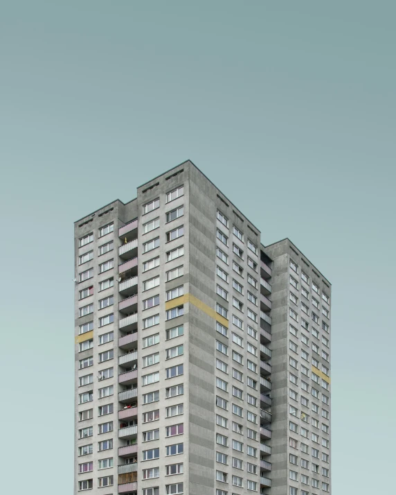 two buildings with tall windows against a blue sky