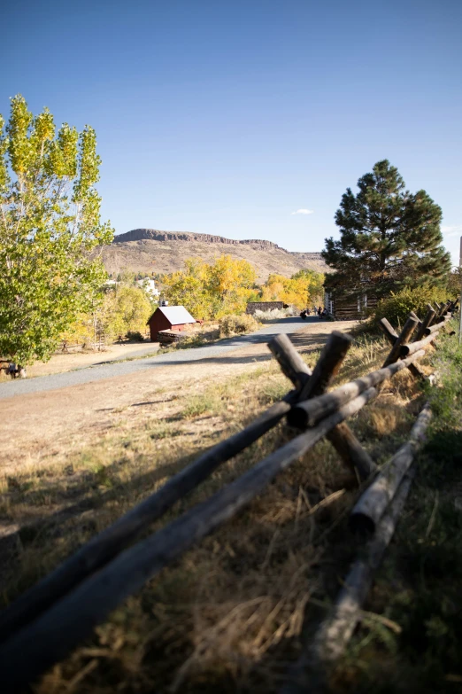 a country road passing a rural countryside with a fence