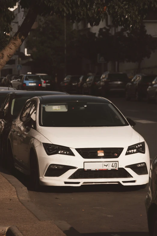 a white car parked on the side of a road