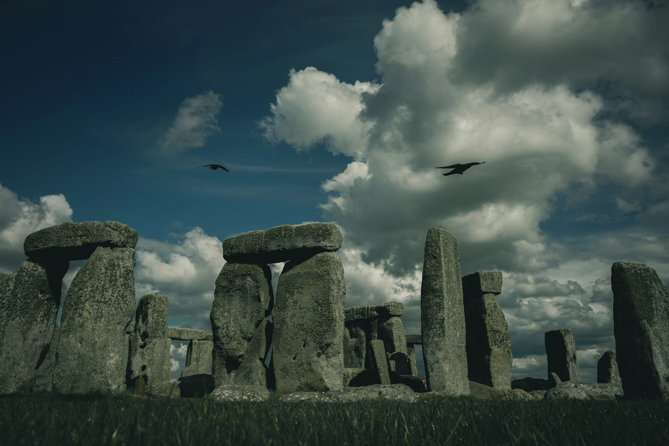 a stonehenge with clouds in the background