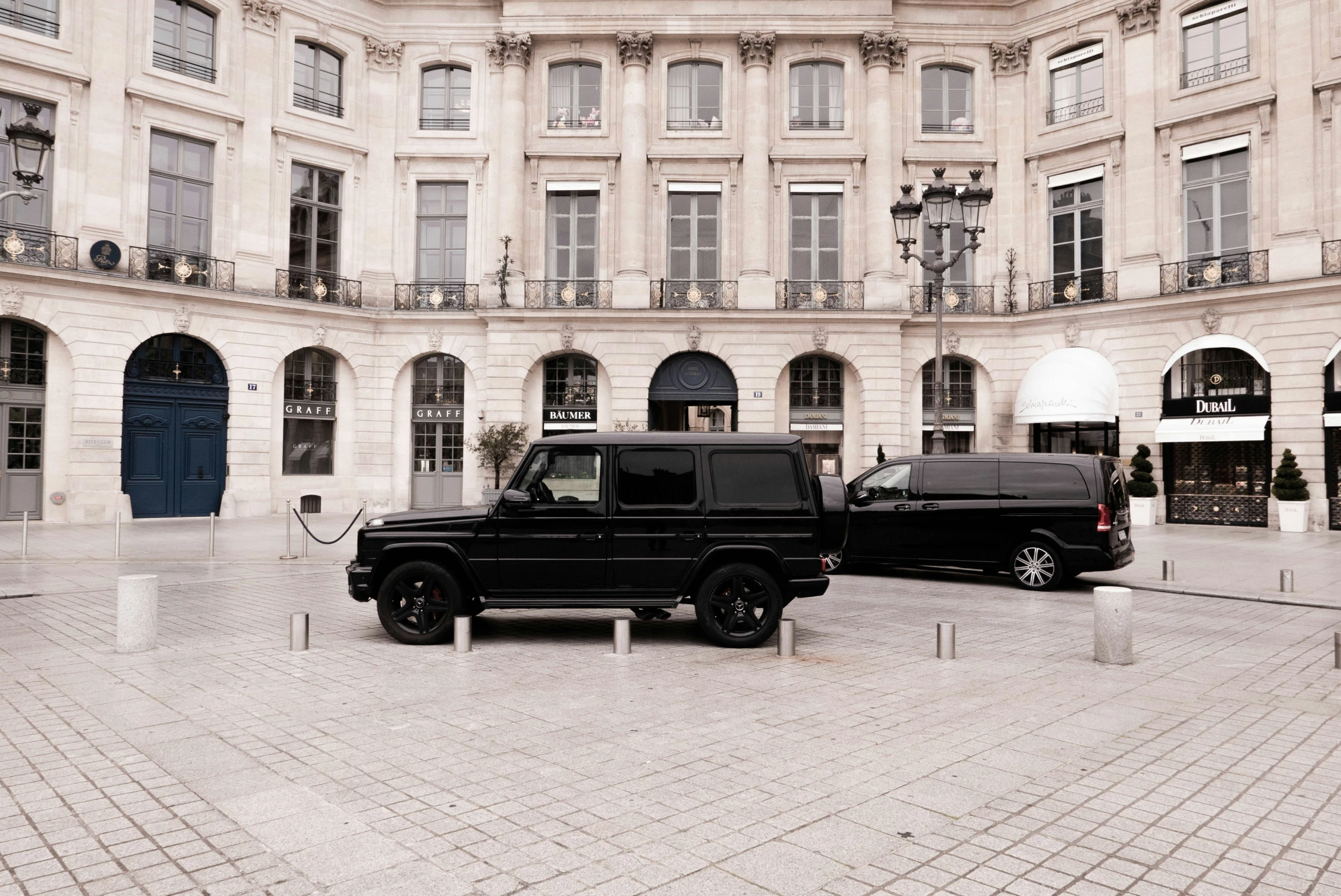 the black truck is parked next to another black truck